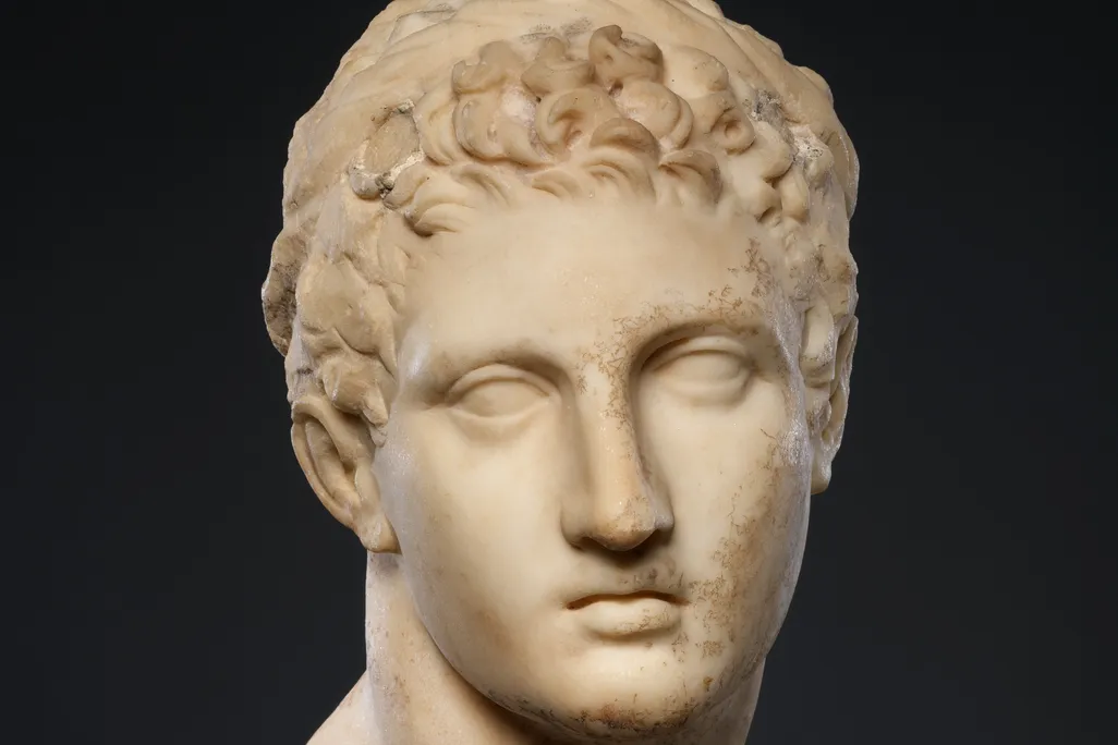 A marble head of a horned youth wearing a diadem ("Marble Head of a Horned Youth"), dated 300-100 B.C.