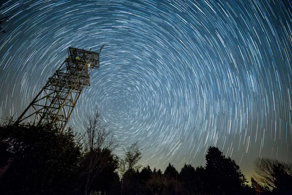 A night sky filled with swirling meteor showers