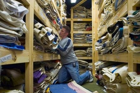 Working for The NAMES Project Foundation, Roddy Williams sorts through portions of the AIDS Memorial Quilt stored in an Atlanta warehouse.