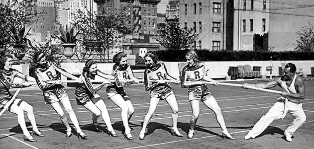 Charles Atlas tug of war with Rockettes