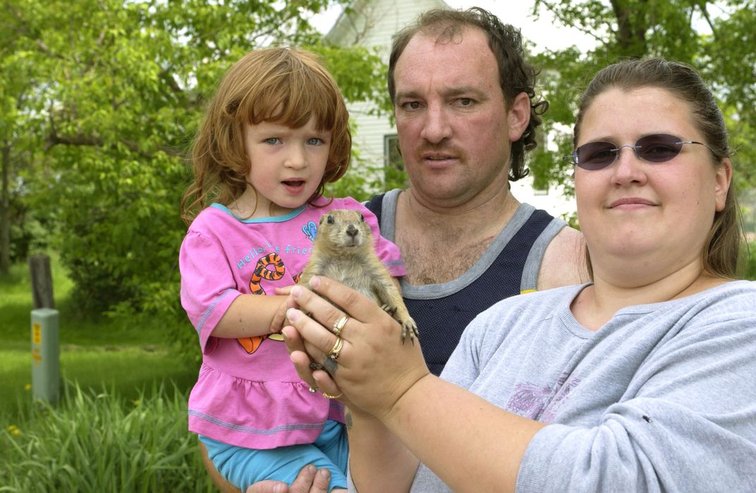 Steve Kautzer holds his 3-year-old daughter Schyan as his wife Tammy (right) holds their prairie dog Chuckles on June 9, 2003, in Dorchester, Wisconsin.