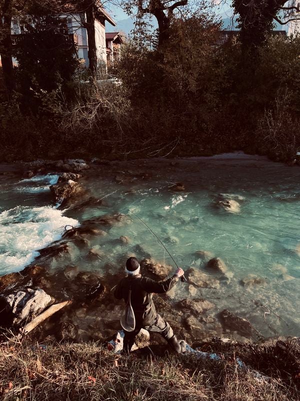 Man fishing on a bright sunny afternoon in Eibsee, Germany thumbnail