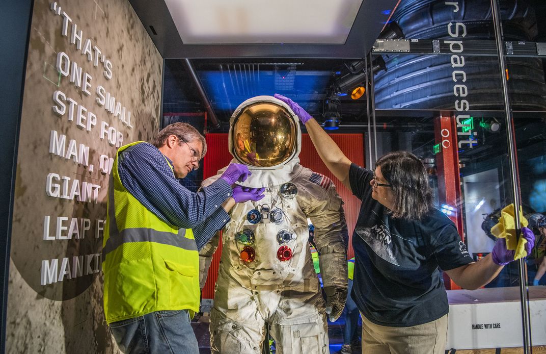 Staff install Neil Armstrongs pressure suit