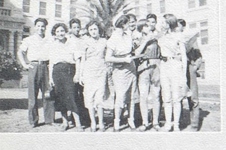 Group of teenagers in front of a school building.