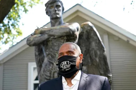 The museum's CEO emeritus, John Guess Jr., stands in front of the newly installed Spirit of the Confederacy sculpture.