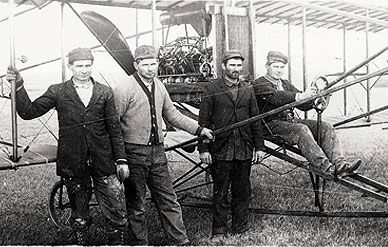 John, Joe, George, and Matt Savidge (from left) with one of their biplanes, ca. 1912. Legend has it that Barney, a one-eyed barn cat, served as test pilot on the scaled-down version. In January 2009, the brothers were inducted into the Nebraska Aviation Hall of Fame.
