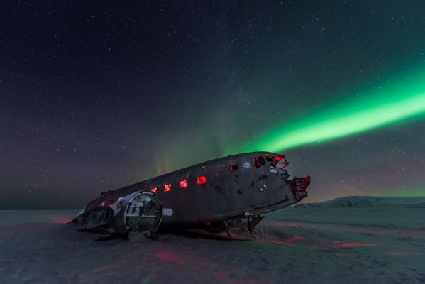 Northern lights over Plane wreckage in Iceland thumbnail