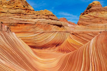 A stunning landscape featuring a wavy sandstone rock formation