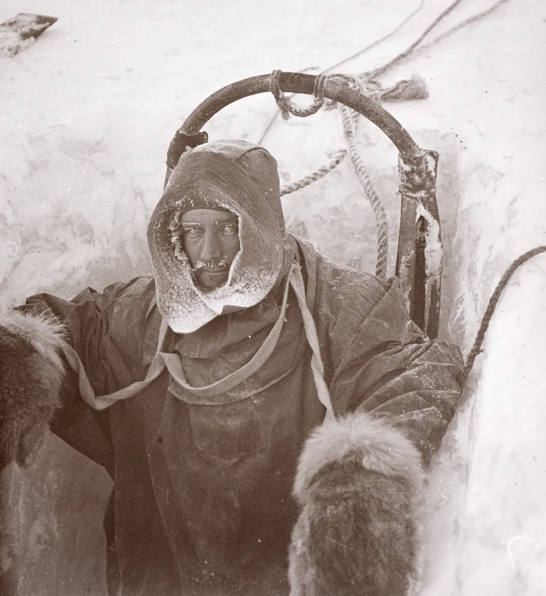 Man wearing cold-weather gear in ice hole