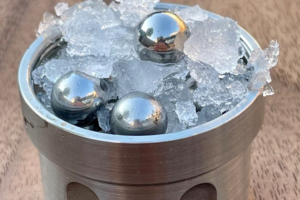 ice and balls in jar on wood table
