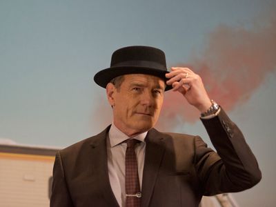 Actor Bryan Cranston impulsively modeled the Heisenberg hat—now a museum artifact—while nervous curators looked on.