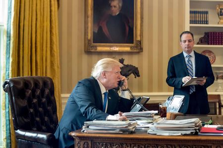 President Donald Trump, accompanied by Chief of Staff Reince Priebus, speaks on the phone with Russian President Vladimir Putin.