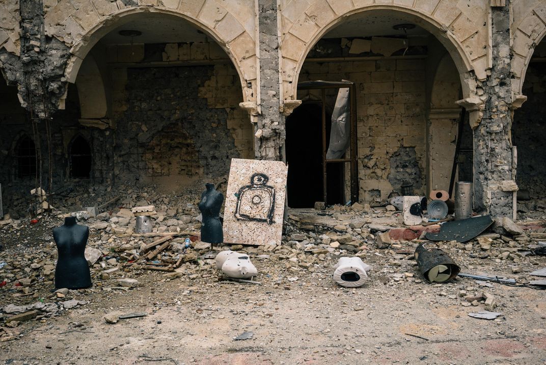 Busts and other targets used by ISIS fighters for shooting practice in the rubble-strewn courtyard of a church in the town of Qaraqosh.