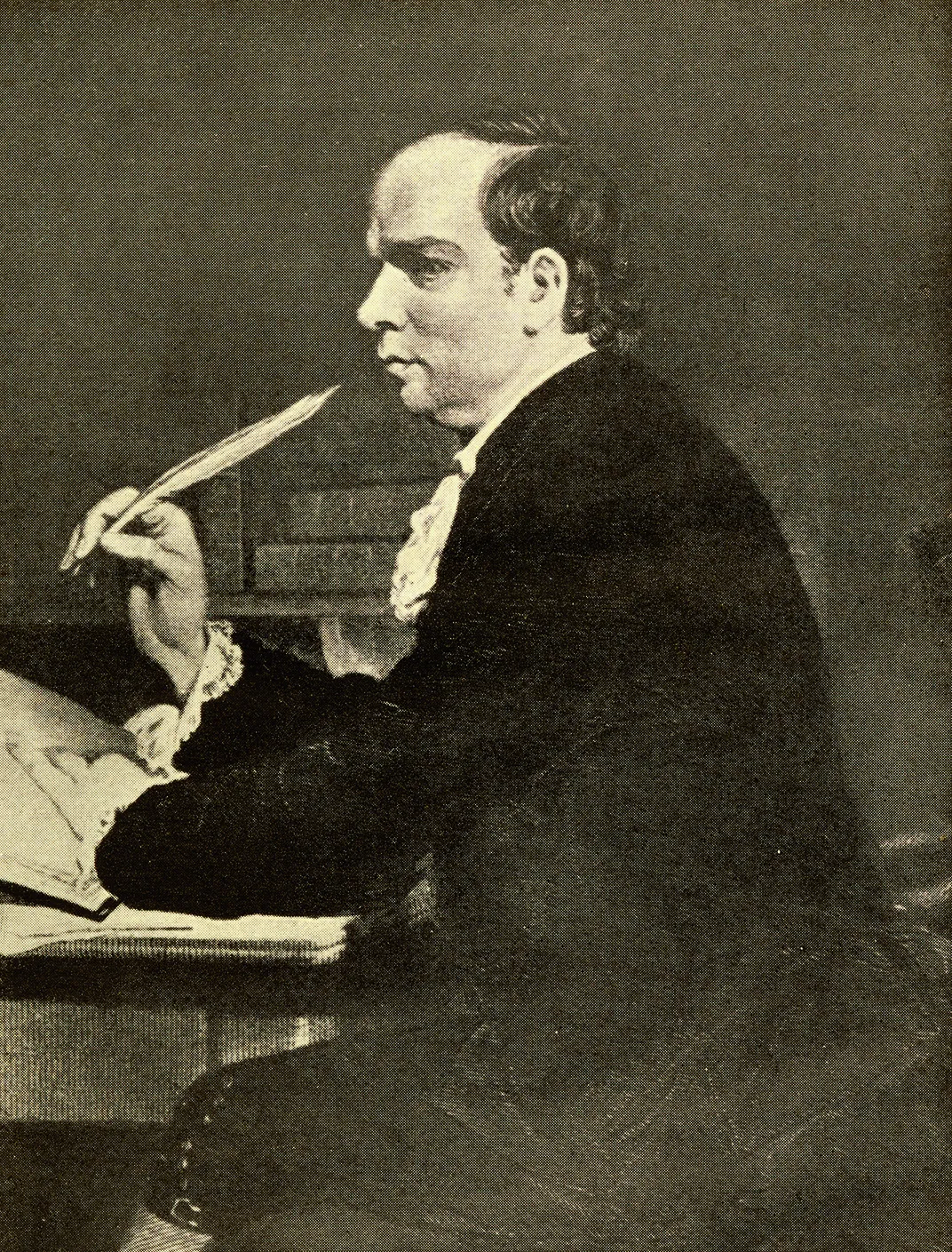 a black and white portrait of a man at a desk writing