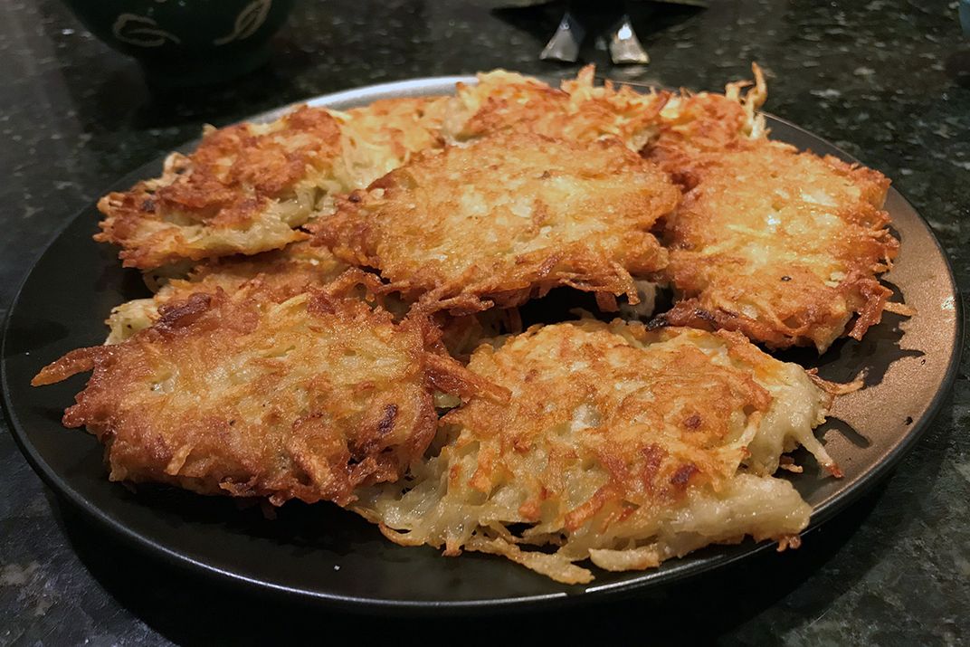 Golden brown potato pancakes on a plate.