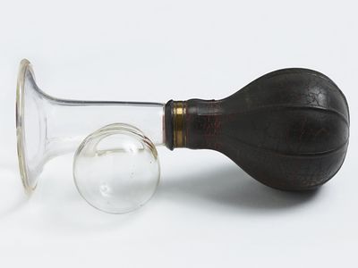 Manual breast pump with black bulb, dating to sometime between 1920 and 1959