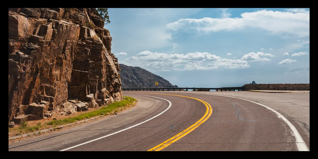 a curved road on the side of a mountain