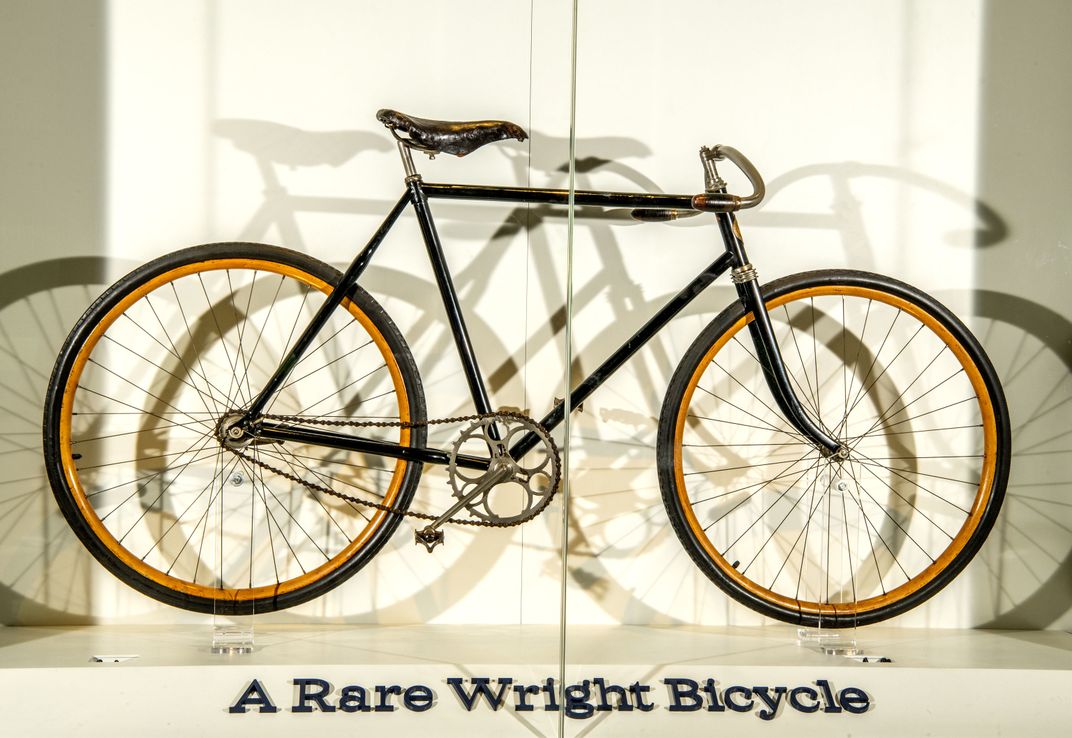 a bicycle in a display case reads "A rare Wright bicycle"