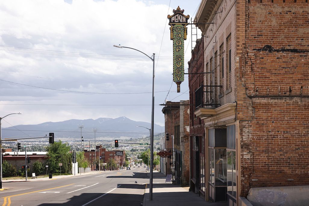 a street in a rural town with mountains in the backgroud