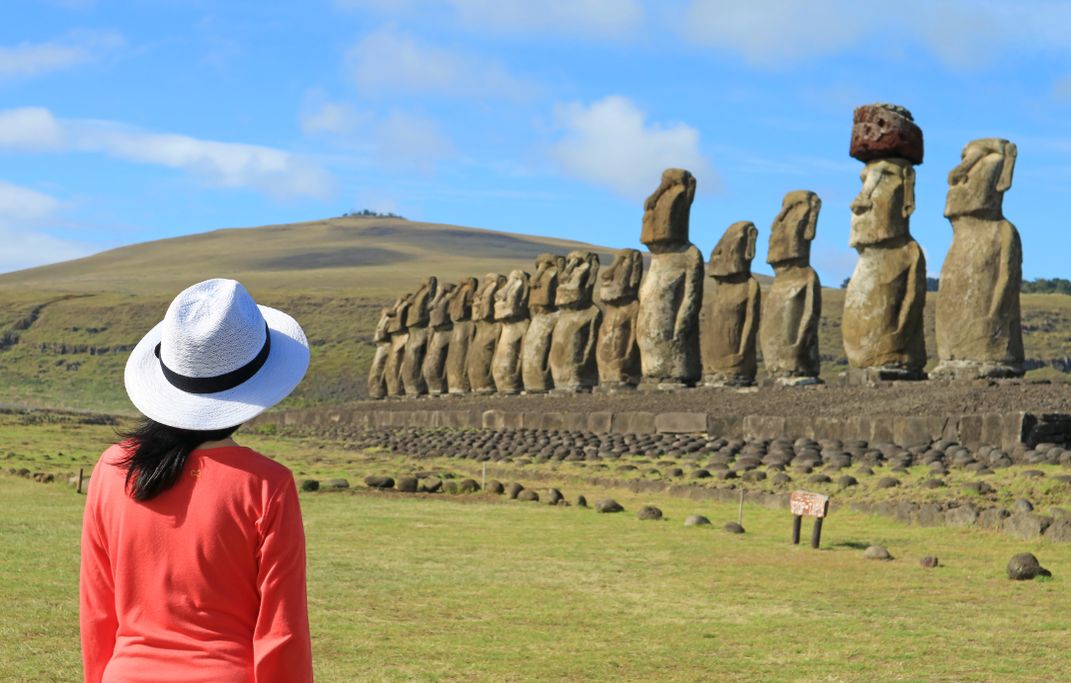Woman at Ahu Tongariki ceremonial platform, Easter Island