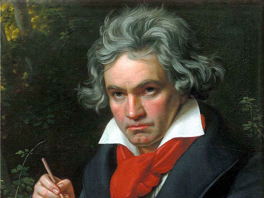 A portrait of Beethoven, a white man with reddish cheeks holding a musical score and a pencil in his hand, wearing a red scarf around his neck with tousled, unruly hair