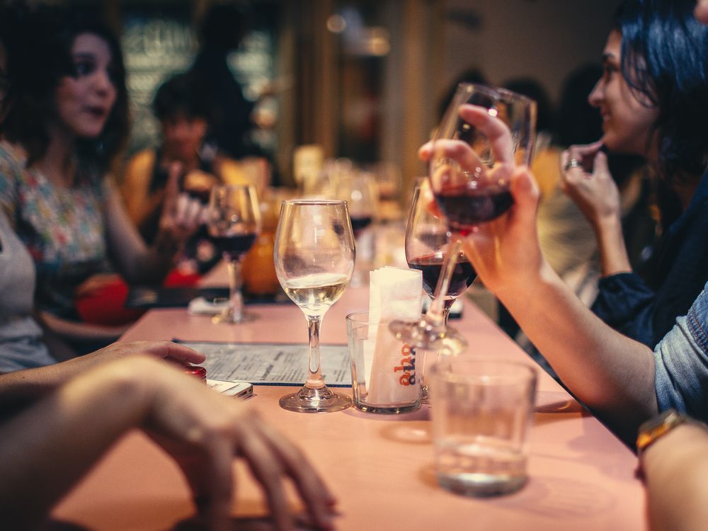 People around a table drinking wine