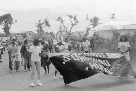 Young people of the U.S. Virgin Islands march along in a carnival parade, amid the destruction of Hurricane Hugo in 1989.