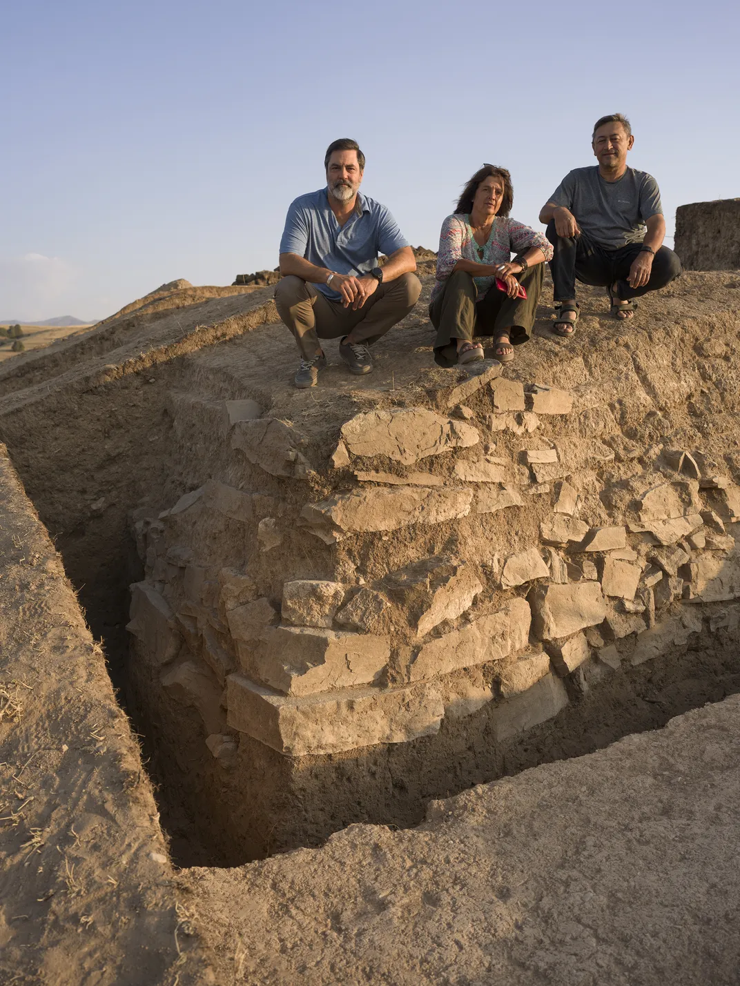 Lead archaeologists  Michael Frachetti, Sanjyot Mehendale and Farhod Maksudov at the site in July. They intend to continue their excavation of Tugunbulak next summer.