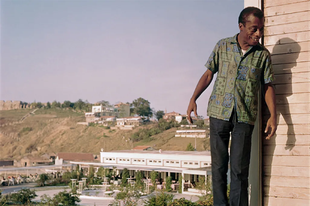 James Baldwin standing on a hotel balcony in Turkey