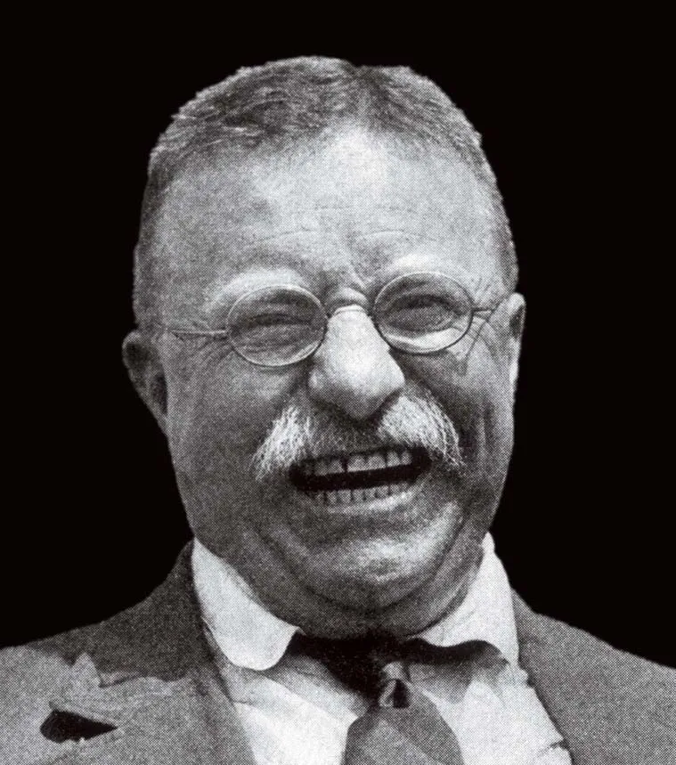 a portrait of a person in glasses laughing madly
