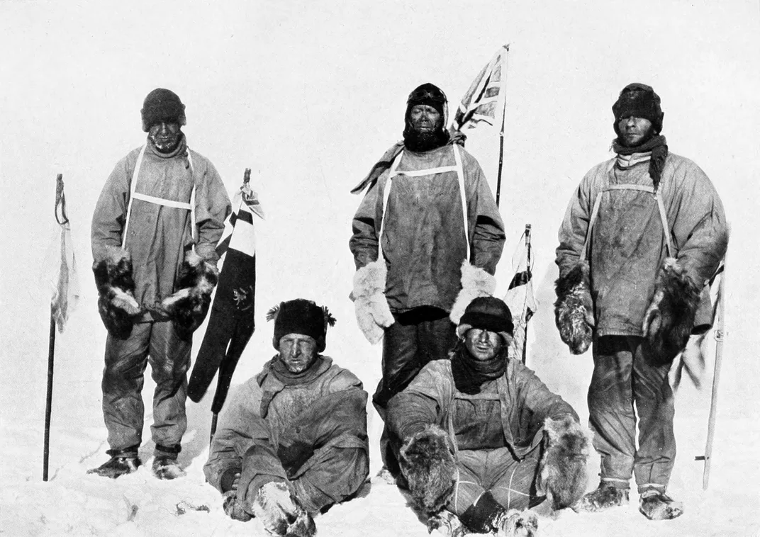 Robert Falcon Scott (standing in front of Union Jack flag) and the crew members of the doomed Terra Nova expedition