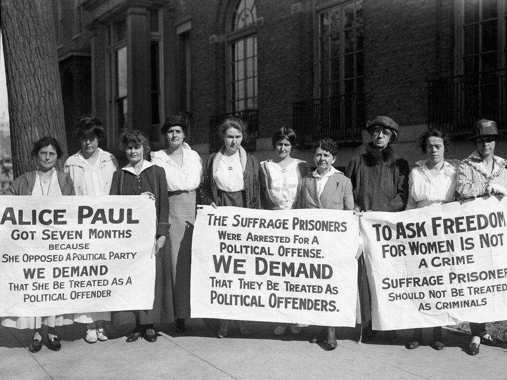 suffragists holding signs demanding political prisoner treatment for Alice Paul