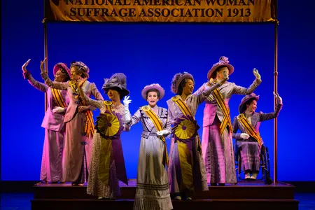 Jenn Colella as Carrie Chapman Catt (center) in&nbsp;Suffs, a new Broadway musical about the women's suffrage movement