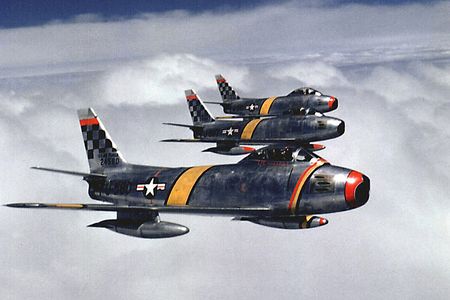 Three F-86s flying in formation over Korea.