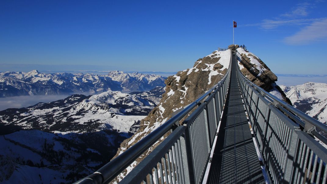 Hiker's suspension bridge spanning Alpine ridges