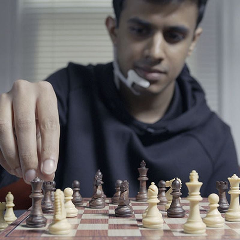 Male chess player with figures in the eyes, thinking process