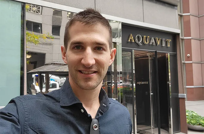 Eric Finkelstein standing in front of Aquavit restaurant