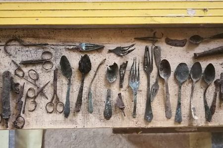 Found in Block 17, the cache includes scissors, shoemaker's tools and utensils.