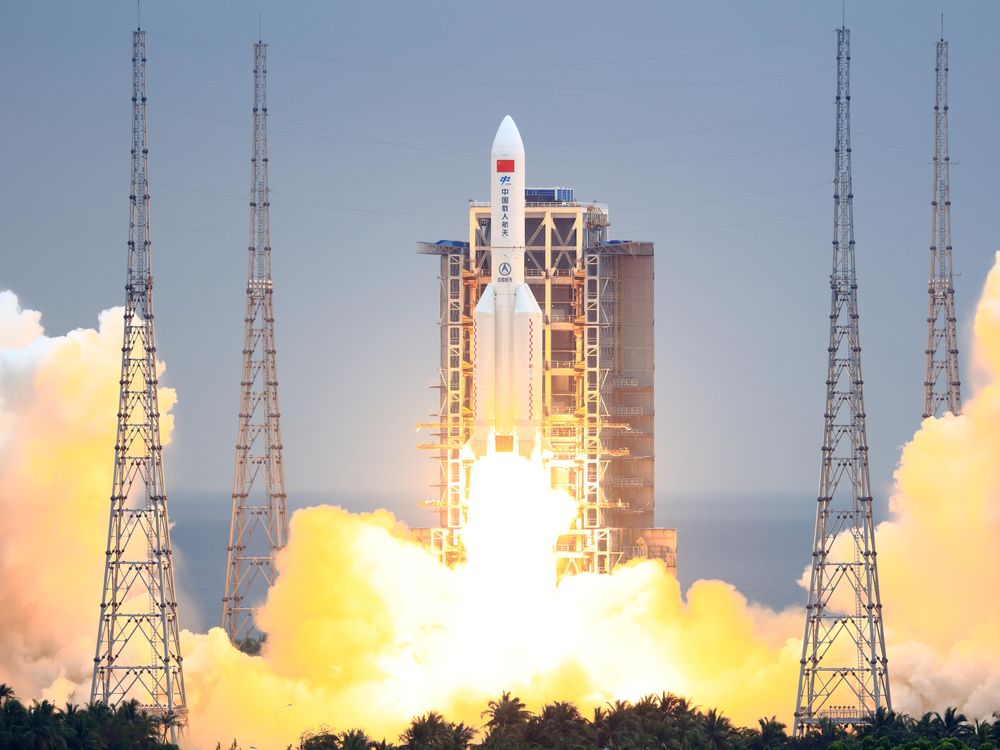 A photo of China's Long March 5B rocket blasting off into space. 