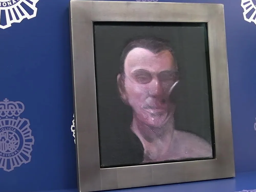 Frame painting of a man's face against a blue background