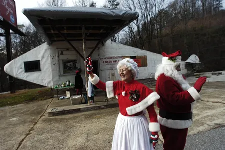Carol Johnson and Tom Milligan wear seasonal attire for a fund-raising appeal at the Airplane Service Station on Saturday in Powell. Members of the Airplane Filling Station Preservation Association were seeking money for Phase II of the landmark's restoration. An anonymous donor will match funds given to the group up to $5,000, with March 31, 2008 as the deadline. The airplane at 6829 Clinton Highway was built in 1930 by brothers Henry and Elmer Nickle and was added to the National Register of Historic Places in 2004. 

Photo by Paul Efird, Knoxville News Sentinel staff