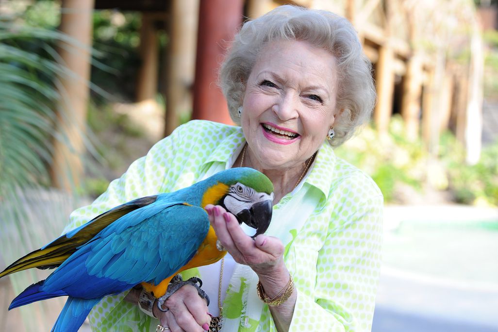 Betty White holds a parrot