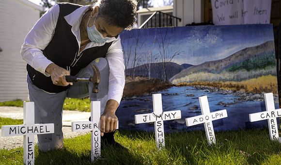 Julia Santos Solomon inserting crosses for her In Memoriam installation, Christ Lutheran Church, Woodstock, NY, 2020. Photo by Scott Barfield.