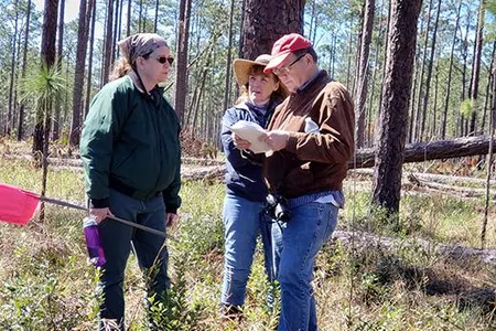 Archeologist Rhonda Kimbrough (left) discusses the survey strategy at Prospect Bluff with author and historian Dale Cox and SEAF Treasurer Janet Bard
