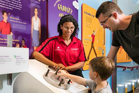 In the National Air and Space Museum’s How Things Fly gallery last September, Explainer Rae Stewart helps a young visitor understand the forces acting on an aircraft in flight.