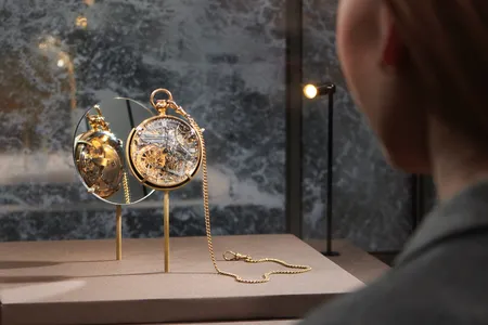 A visitor examines a watch&nbsp;crafted by&nbsp;Abraham-Louis Breguet&nbsp;for Marie Antoinette.