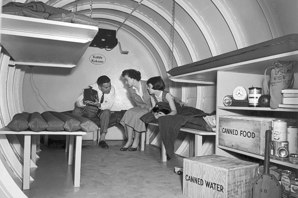A Long Island family sits in a "Kidde Kokoon" underground bomb shelter in 1955.