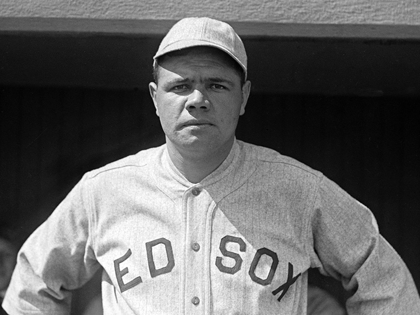 Babe Ruth, wearing a Red Sox uniform, looks squarely at the camera