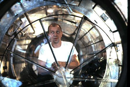 Mattingly inspects an airlock made for Gemini astronauts to practice spacewalks underwater.