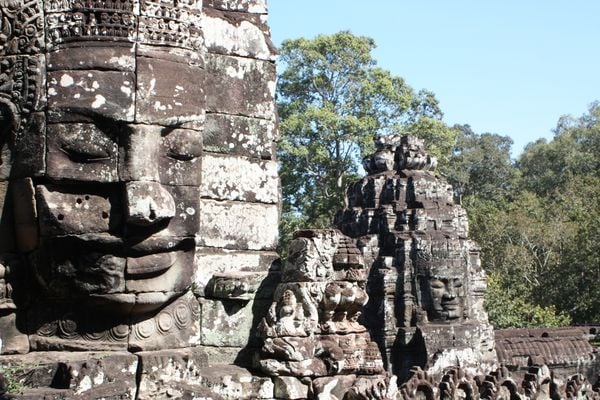 Temple faces at Angkor Wat emerge from jungle thumbnail